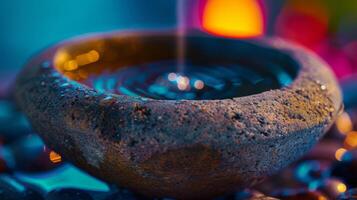 The rustic charm of a stone oil diffuser carved into a bowl shape and filled with water and drops of essential oils photo