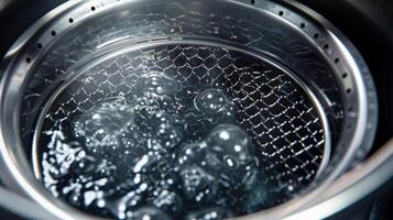 A detailed shot of the oil filter mesh inside the deep fryer capturing any debris to maintain the oils freshness photo