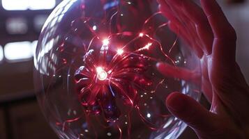With the touch of a finger electricity surges towards the edges of the plasma ball creating a dazzling display photo