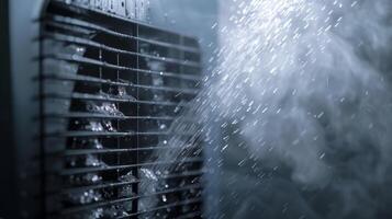 A dehumidifier in action with water droplets visible on the cooling coils and a steady stream of air being released from the front vents photo