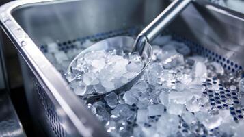 A small shovel or scooper resting on top of the ice maker used to easily remove ice from the bucket photo