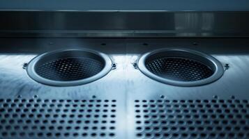 A closeup of the air vent openings on an exhaust fan emitting a strong breeze photo