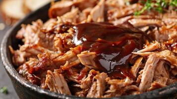 A scoop of tender pulled pork from a crockpot topped with tangy barbecue sauce photo