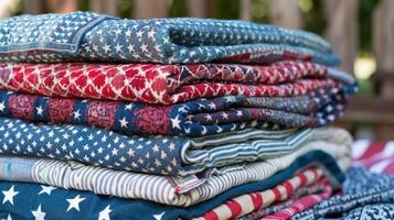 A stack of picnic blankets each with a different patriotic pattern ready to be spread out for a day at the park photo