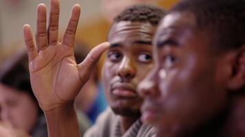 A closeup of a student leaders face shows determination and passion as they address their fellow club members during a meeting. Their hand is raised in emphasis driving hom photo