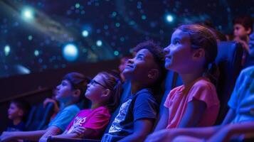 Inside a planetarium students sit in awe as they are transported through time and space learning about the history of astronomy and the many wonders of the universe photo