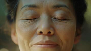 A closeup of a persons eyes closed in meditation while practicing Tai Chi their breath deep and steady as they connect with their mind and body photo