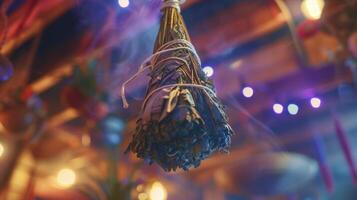 A bundle of dried sage hangs from the ceiling symbolizing the cleansing and healing powers of traditional smudging rituals photo