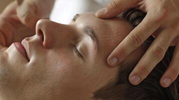 A persons hand applying gentle pressure to the reflex point on the ear that is believed to stimulate the digestive system and aid in digestion photo