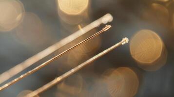 A closeup of the acupuncture needles used in the therapy is the focus of the third image. They are thin sterile and inserted gently into specific points on the body to stimulat photo