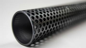An upclose shot of a slender black tube with intricate patterns etched onto its surface. innovative material is designed to manipulate sound waves allowing for precis photo