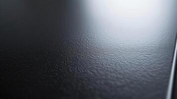 A closeup of an aerographitecoated surface displaying a smooth and seamless finish with a slight sheen to it photo