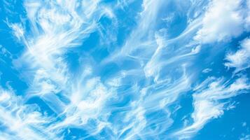 Wispy clouds form intricate patterns against the bright blue sky creating a captivating and everchanging display photo