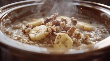 A bowl filled with oatmeal, topped with a mixture of nuts and slices of ripe bananas photo