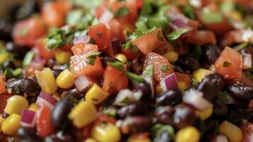 A detailed view of a salad featuring black beans, corn, tomatoes, and cilantro, showcasing a colorful and nutritious mix of ingredients photo