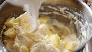 A mixing bowl containing a creamy mixture of ice cream and sliced bananas photo
