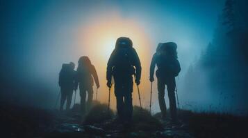 A team of adventurers identities concealed by the darkness forging ahead through the mist towards next mysterious destination. . photo