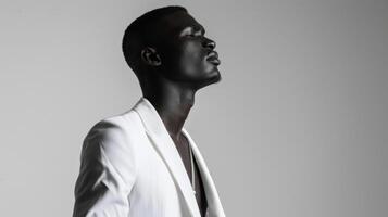 A black man standing tall in a striking allwhite ensemble his chiseled features and impeccable style demanding attention on the catwalk. With his head held high and a bold statement photo