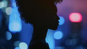 A striking silhouette of a powerful black woman her sharp features outlined against the soft glow of city lights. She exudes a timeless glamour that captures the eye with its mysterious photo