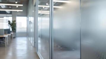 Along the walls of the office frosted glass partitions create designated spaces for brainstorming and impromptu meetings. The frosted finish provides a level of privacy while still photo