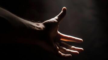 A hand reaches out from the shadows as if trying to escape the darkness and grasp onto soing tangible. photo