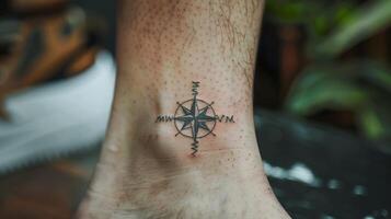 Nestled on their ankle a small tattoo of a compass serves as a reminder to always follow their true north. photo
