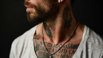 Across their collarbone a bold and intricate quote tattoo reminds them to stay strong in times of adversity. photo