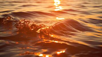 The golden sun sinking below the horizon, casting a warm glow on the rippling water. photo