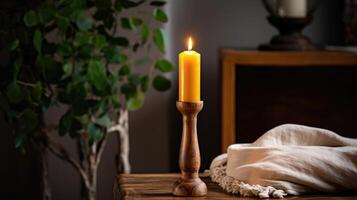 A handcarved wooden candlestick holding a tall, slender candle with a honeyed amber hue and a faint scent of vanilla, perfect for setting a romantic mood in a rustic bedroom. photo