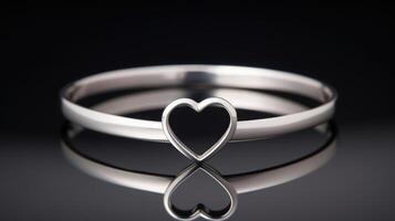A sleek and modern heartshaped bangle, featuring a clean and minimalistic design with a smooth silver finish. photo