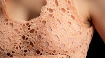 Closeup of a delicate Peach Fuzz blouse, created from sustainable bamboo fabric. The intricate stitching and subtle peachy hue make this top a sustainable fashion statement. photo