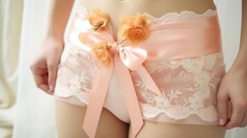 Closeup of a Peach Fuzz garter belt, adorned with intricate lace and delicate satin bows for a touch of glamour. photo