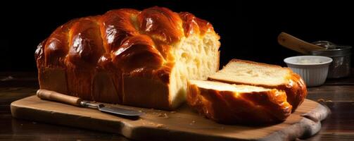 A slice of Challah bread showcases its delightfully airy and fluffy interior, with its unevenly tered air pockets adding to its texture. photo