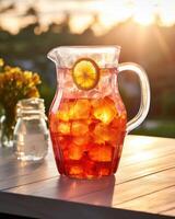 A translucent pitcher showcases the captivating hue of sugary iced tea, reflecting light like a mesmerizing sunset on a summer evening. photo