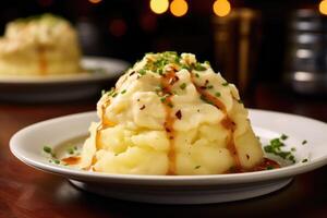 A dreamy, whipped concoction of mashed potatoes is elevated with the addition of smoked Gouda cheese, as it cascades over the edges, infusing each bite with its distinct smoky undertones. photo