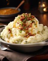 An explosion of flavors awaits with cheesy mashed potatoes accompanied by crispy, sizzled bacon crumbles, resulting in a delightful union of smoky, creamy, and savoury notes that are photo