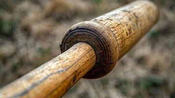The wooden bat closeup and weathered from years of use on the field photo