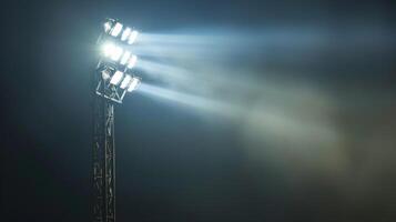 An upclose shot of a single floodlight its beam shining brightly down onto the field below photo