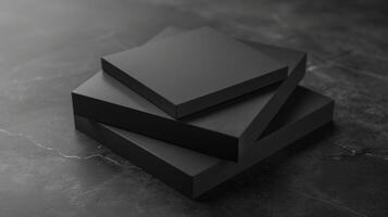 Blank mockup of a stack of sleek and modern black shipping boxes with a simple white log photo
