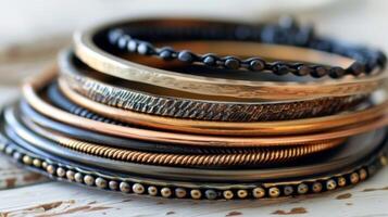A set of stacked bangle bracelets in different metals and textures perfect for adding an extra layer of interest to any outfit photo