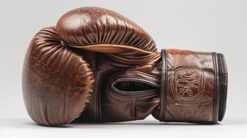 Image Description A highquality leather boxing glove with a sleek and simple design. The brands logo is embossed on the wrist s photo