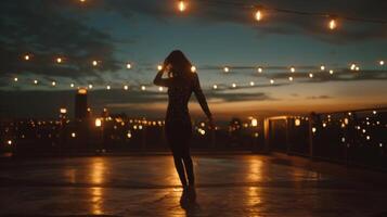 A lone dancer twirls in the spotlight face hidden as they let the music move them on the rooftop surrounded by glowing string . photo