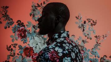 A captivating portrait of a black man his silhouette outlined in striking floral patterns against a serene dreamy background. The minimalistic lighting adds a touch of mystery and photo