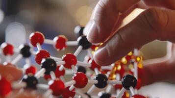 A closeup of a scientists hand carefully holding a molecular model highlighting the precise symmetry required in creating efficient biofuels. photo