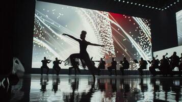A dancer gracefully moves through a performance accompanied by a live orchestra. In the background large screens display abstract visuals that represent the transformation of biowaste photo