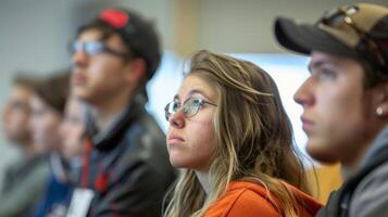 A group of students attending a seminar on biofuel technology led by an expert in the field. They are actively engaged in learning about the advancements in the industry highlighting photo