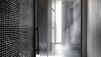 The bathroom features a steel grating shower screen adding an unexpected element to the otherwise sleek and minimalist space. The grating provides privacy while still allowing light photo