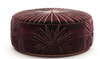 A round velvet ottoman covered in a rich burgundy fabric and embellished with a metallic gold sunburst design. The opulent color and intricate pattern add a touch of Art Deco elegance photo