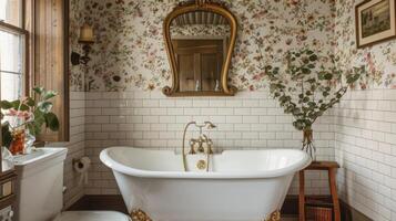 The bathroom features a clawfoot bathtub surrounded by white subway tiles and accented with a vintage brass faucet. The walls are clad in a romantic floral wallpaper adding a pop of photo