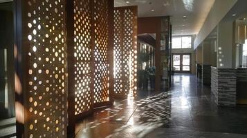 Utilizing a mix of solid and perforated metal the room dividers feature a geometric pattern that adds visual interest to the space. The light filtering through the perforations casts photo